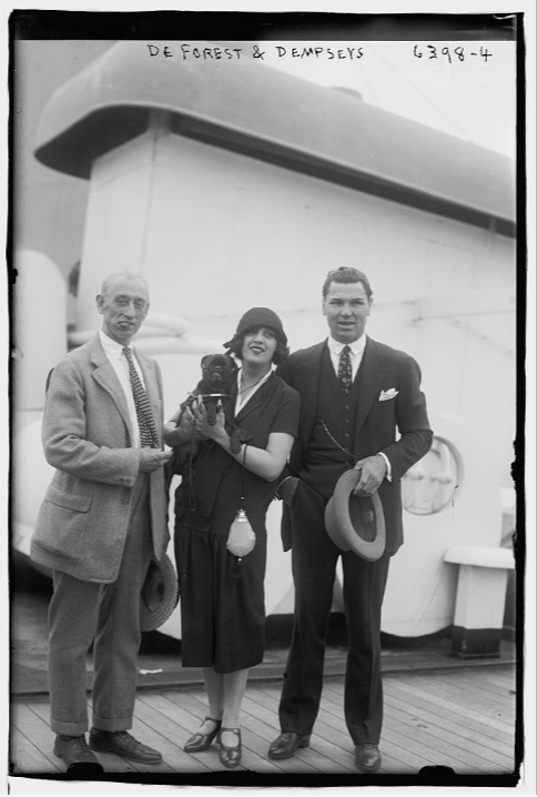 Boxer Jack Dempsey, his wife Estelle Taylor, and trainer Jimmy DeForest.  Bain News Service, publisher, date unknown. George Grantham Bain Collection, Library of Congress, public domain.