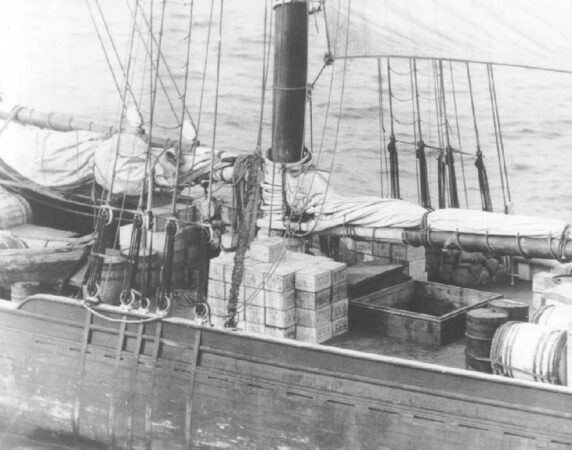 Photograph of rum-runner schooner Kirk and Sweeney with contraband stacked on deck. Coast guard Photo No. G-APA-01-13-24 (02) G.F. January 13, 1924, Public Domain.