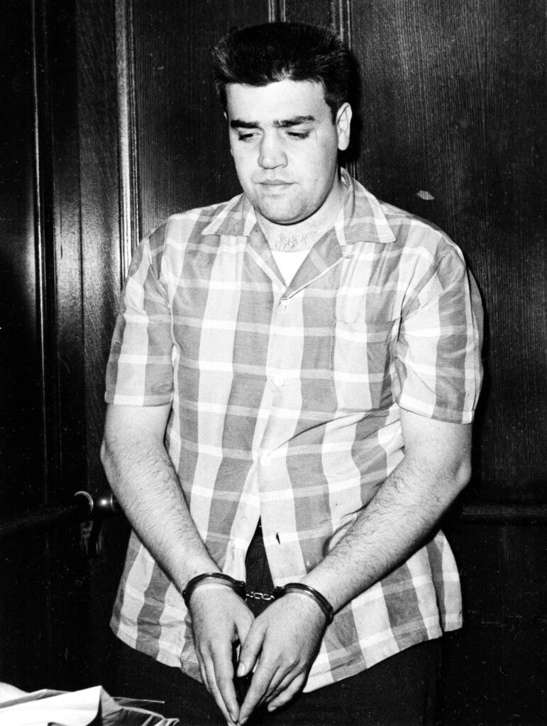 Vincent L. Gigante is handcuffed as he arrives at Federal Courthouse in New York City, July 8, 1958.  Judge William B. Herlands, before whom Gigante and Vito Genovese were arraigned on narcotics conspiracy charges, set Gigante's bail at $35,000.  Both Gigante and Genovese pleaded innocent through their attorneys.  (AP Photo)