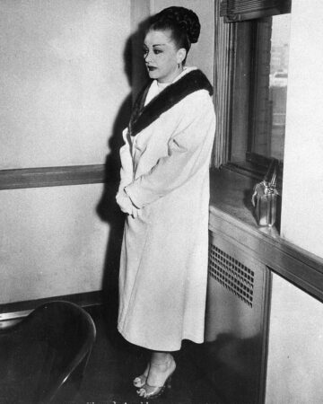 Anna Genovese, wife of racketeer Vito Genovese, stands in an office in Trenton, NJ., on Dec. 12, 1957. (AP Photo)