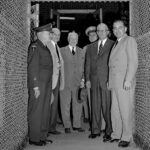 Sen. Joe McCarthy, right, Secretary of Army Robert T. Stevens, second from right, and New Jersey congressmen leave the Evans Signal Laboratory at Fort Monmouth, N.J., Oct. 20, 1953, where they had been investigating possible security leaks at the Army Signal Corps Radar Laboratories. At the gate are, left to right: Maj. Gen. Kirke B. Lawton; Sen. H. Alexander Smith (R-N.J.); Rep. James C. Auchincloss (R-N.J.); Maj. Gen. George I. Back, chief of the Army Signal Corps; Stevens and McCarthy. McCarthy told newsmen he hopes to find new leads for purported spy ring operating within the radar center. (AP Photo)