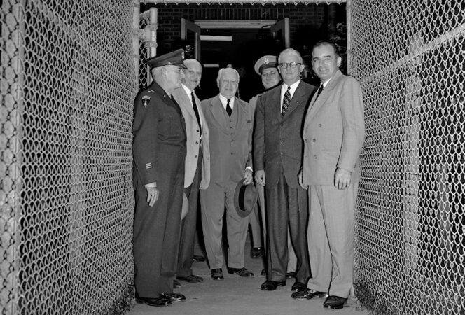 Sen. Joe McCarthy, right, Secretary of Army Robert T. Stevens, second from right, and New Jersey congressmen leave the Evans Signal Laboratory at Fort Monmouth, N.J., Oct. 20, 1953, where they had been investigating possible security leaks at the Army Signal Corps Radar Laboratories. At the gate are, left to right: Maj. Gen. Kirke B. Lawton; Sen. H. Alexander Smith (R-N.J.); Rep. James C. Auchincloss (R-N.J.); Maj. Gen. George I. Back, chief of the Army Signal Corps; Stevens and McCarthy. McCarthy told newsmen he hopes to find new leads for purported spy ring operating within the radar center. (AP Photo)