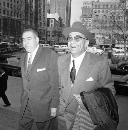 Reputed mobster Vito Genovese smiles as he arrives at the federal courthouse in New York, April 17, 1959, where he was scheduled to be sentenced for his conviction on narcotics charges. At left is Wilfred Davis, his attorney. (AP Photo)