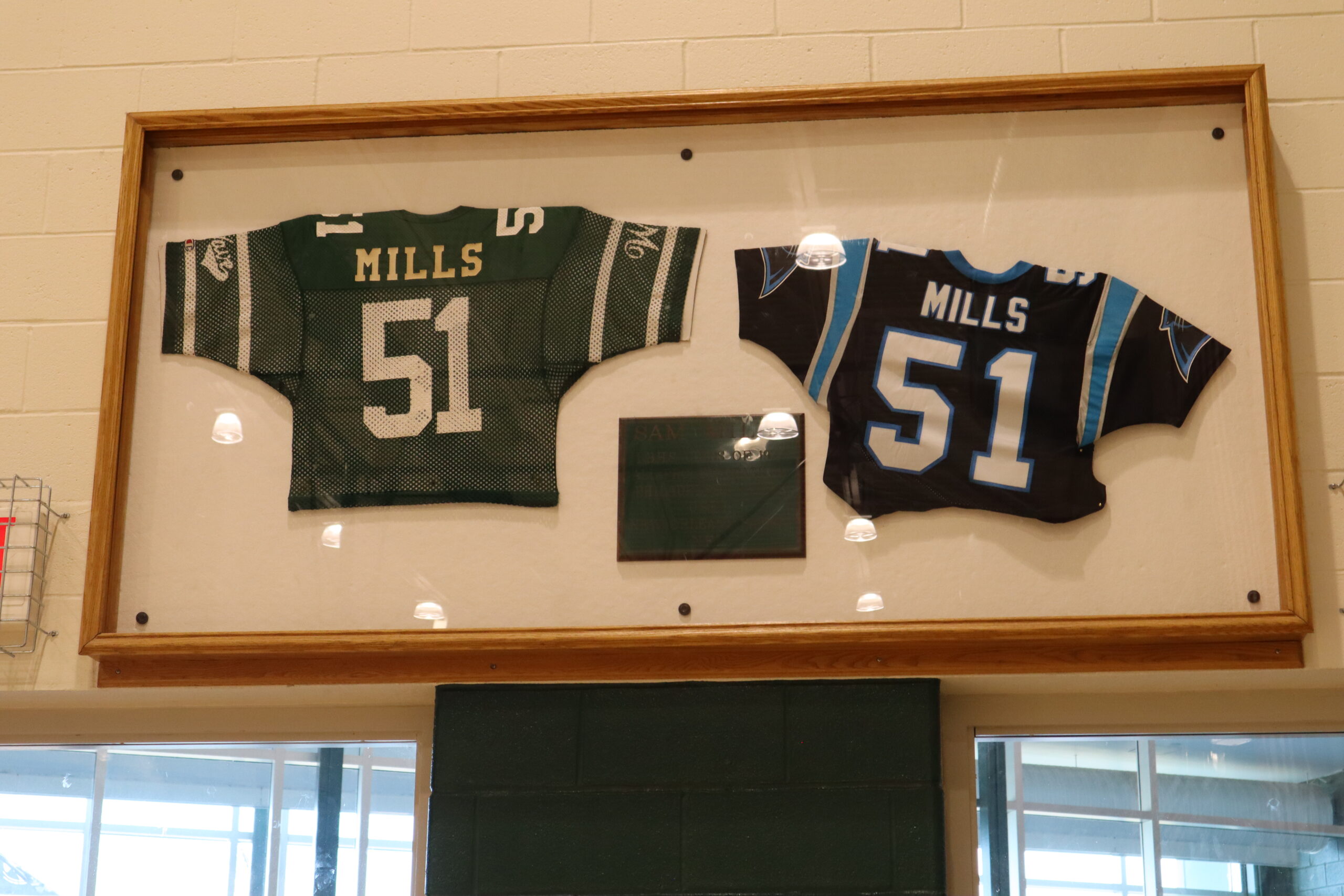 Sam Mills jerseys hanging in the athletic center at Long Branch High School. Photo by John R. Barrows.