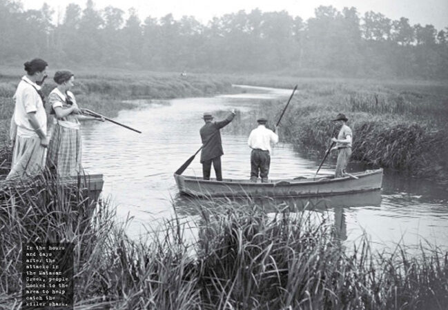 Photograph of men in a rowboat in Matawan Creek looking for sharks while women look on holding a shotgun.