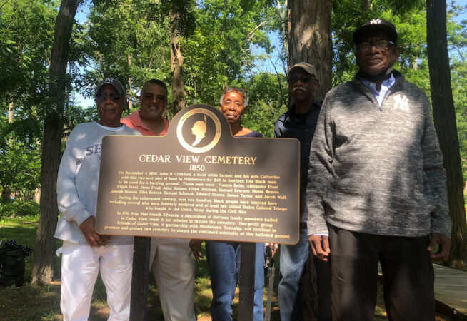 Photo of Cedar View Cemetery board members with Cedar View sign
